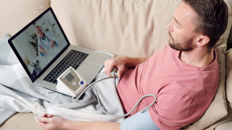 remote monitoring man taking his blood pressure